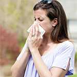 A woman sneezing.