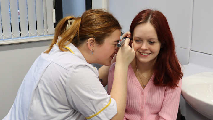 Student Charlotte Manford practicing an examination on another student.