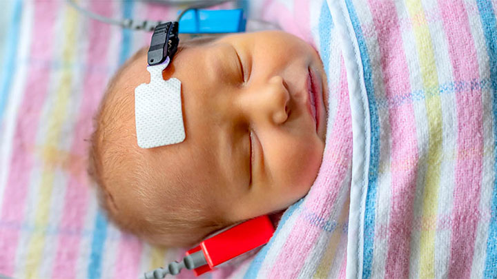 A baby having a hearing test.