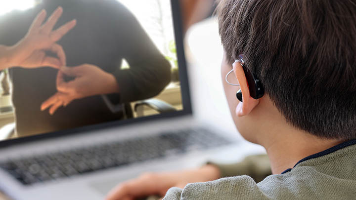 A Deaf student having an online lesson in sign language.