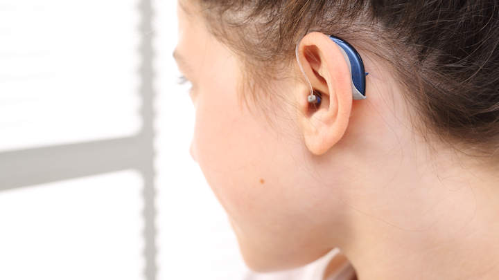 A person wearing a hearing aid.
