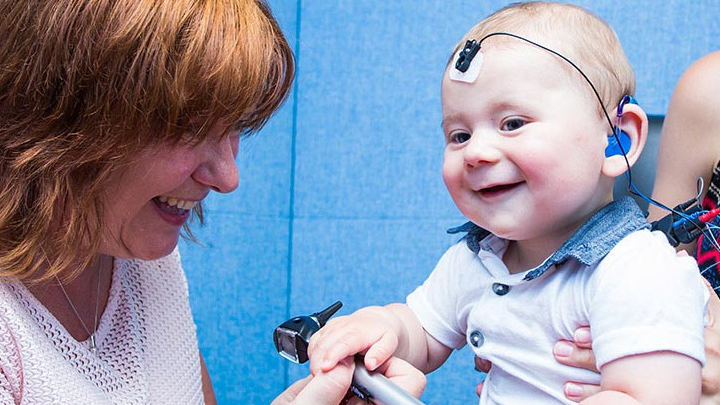 A baby having a hearing test in the 'van'.