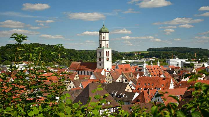 A view of a town in Germany with a white church standing out.