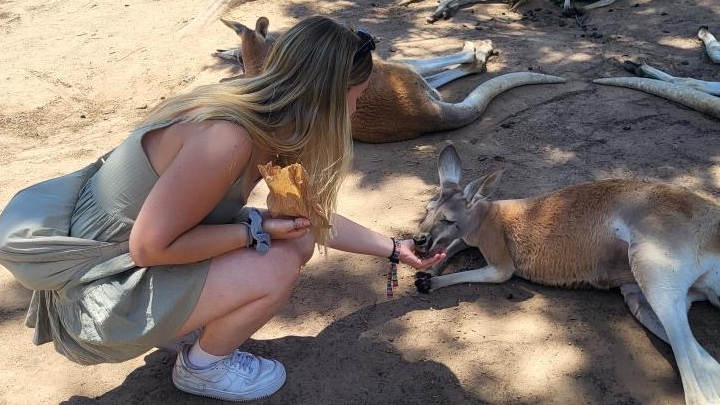 A photo of Maddy with animals in Australia.