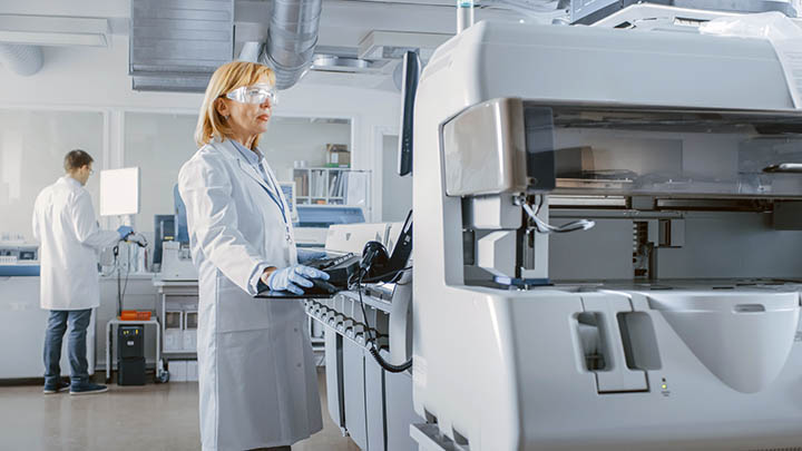 A researcher using equipment in a modern lab.
