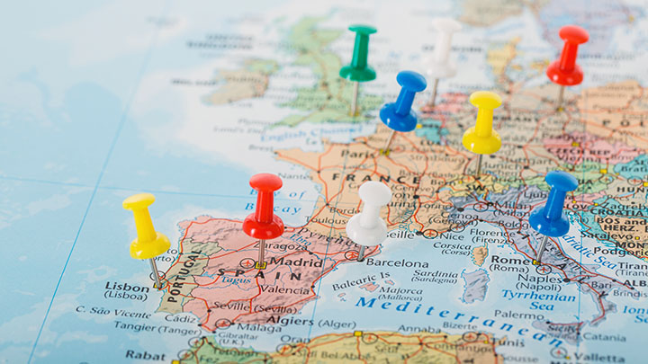 A map of Europe with colourful map pins in several countries.