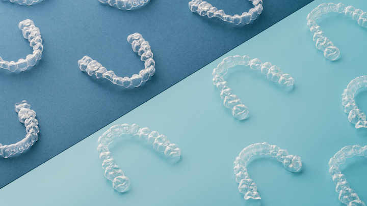 Teeth retainers on a coloured background.