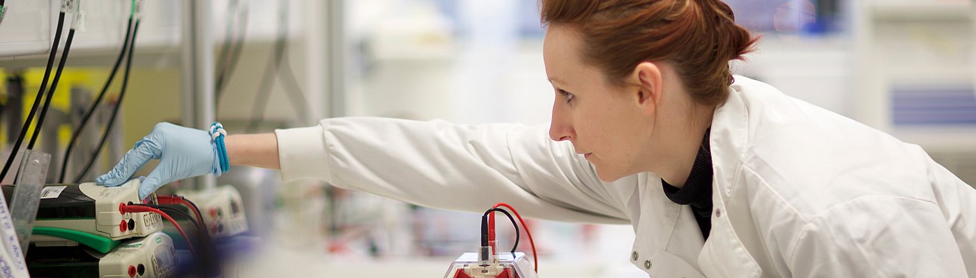 Student checking equipment in lab