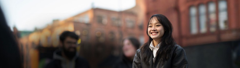 A student standing on a street.