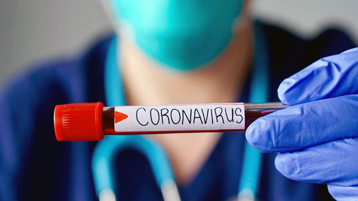 A doctor holding a blood sample from a patient infected with coronavirus.