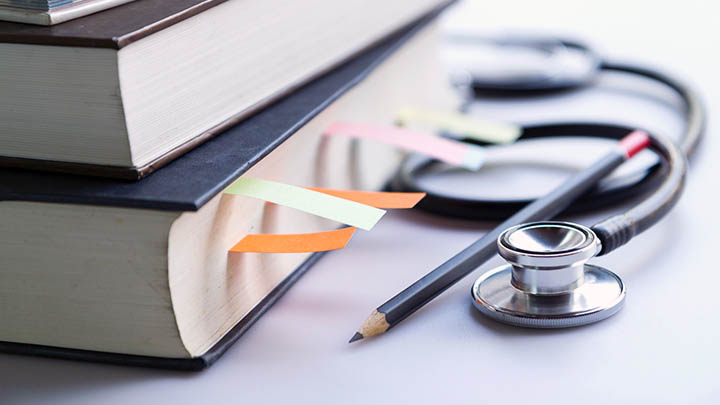 Medical books with tabs inserted to mark pages.
