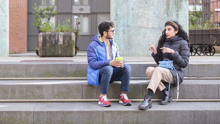 International students having a conversation outside.