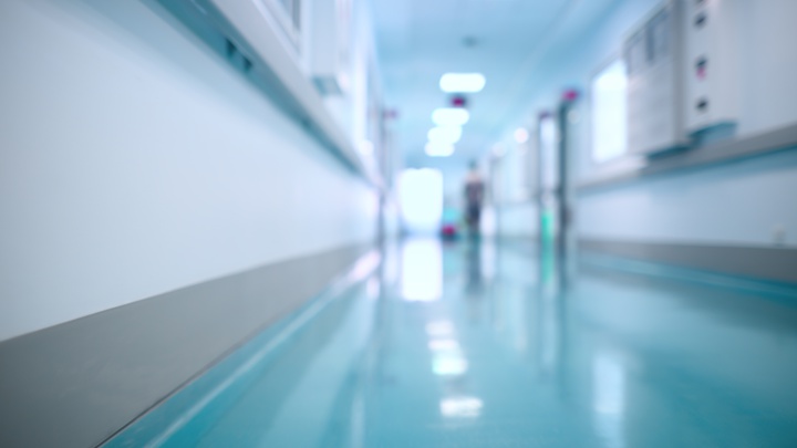 A blurred photo of a corridor in a hospital.