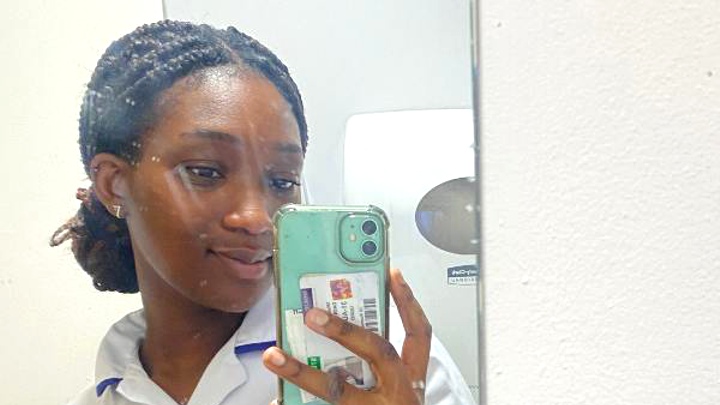 Wise taking a selfie in her uniform.