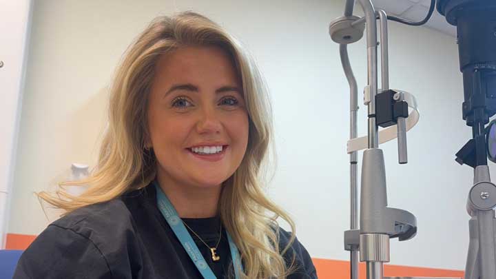 Student Emily, smiling towards the camera in a clinical setting. 