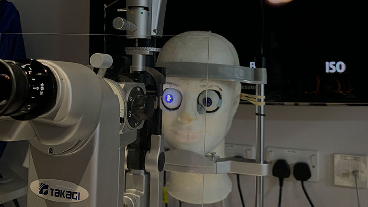 An optometry dummy is being used to practice key optometry techniques.
