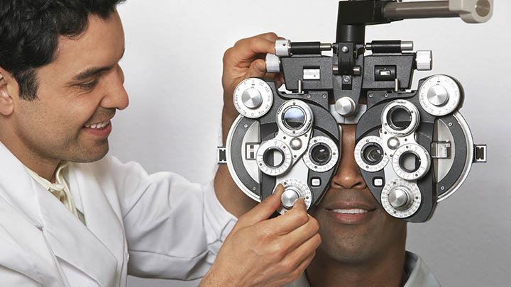 Student using a phoropter during an eye examination.