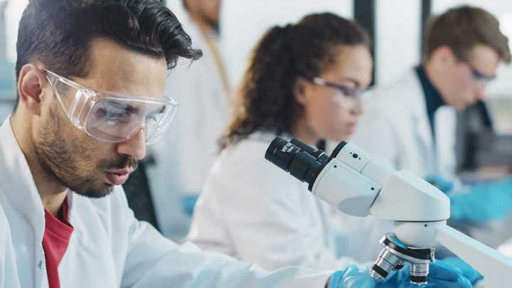 Three postgraduate researchers in a lab.