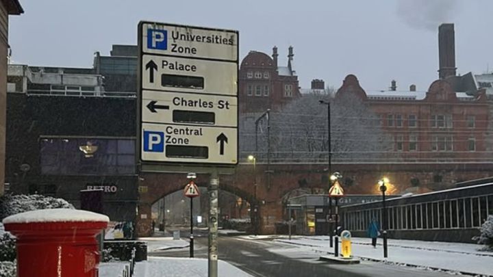 A road sign on a snowy road in Manchester.