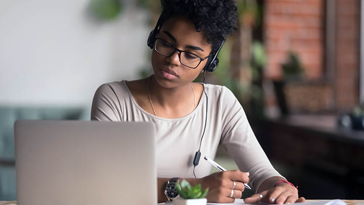 A student listening to a podcast.