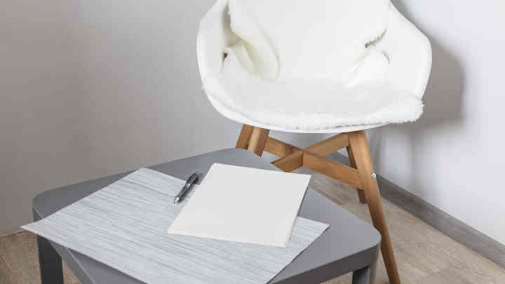Table with a notepad and pen on it.