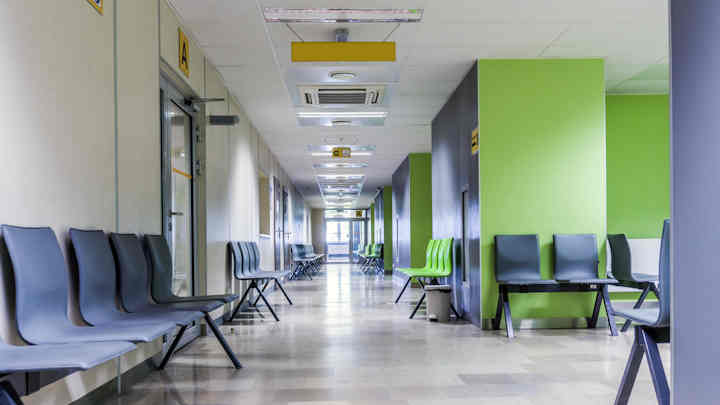Hospital corridor with chairs for waiting patients.