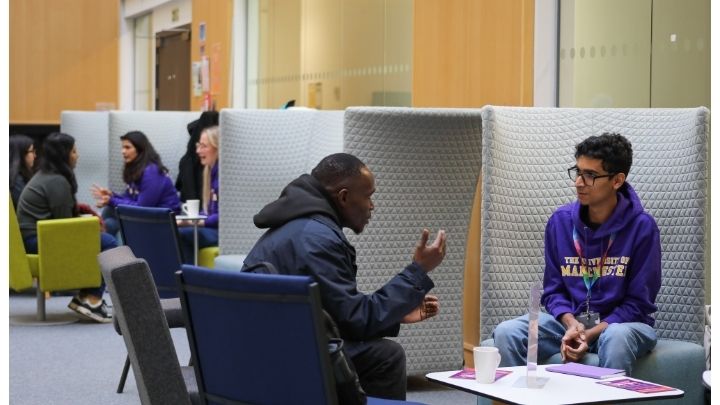 A current postgraduate researcher sat talking to a student