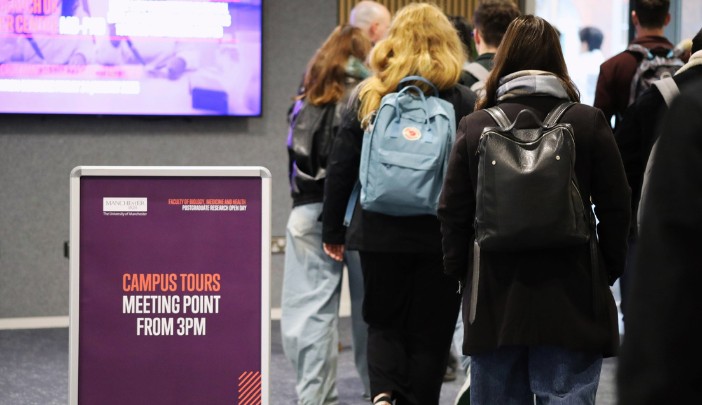 Open Day attendees walk past a 'Campus tour' sign