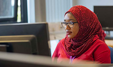 A PhD student working at a computer.