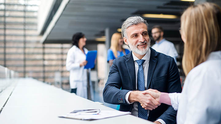 A postgraduate student chatting with a mentor.