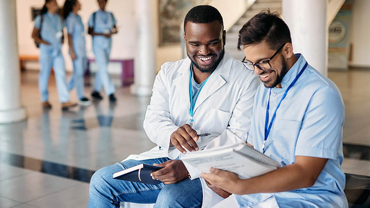 Two medical students laughing together.