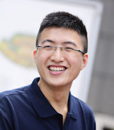 A male Chinese student smiling.