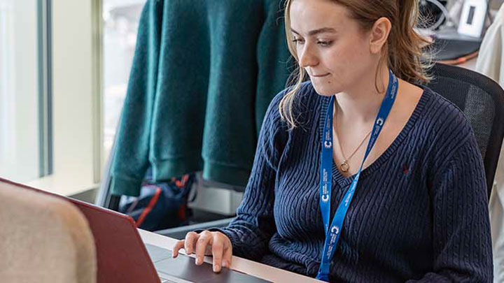 A postgraduate researcher working on a computer.