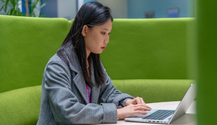 One person sat looking at a laptop