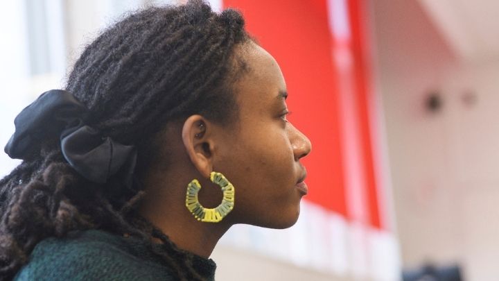 A postgraduate researcher sat in a workshop talking to a coach