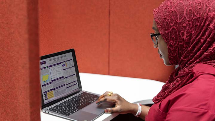 A postgraduate researcher working on a laptop.
