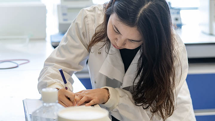 Kar, a PhD student, updating a lab book.
