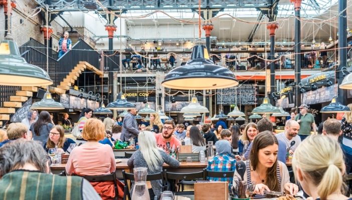 People dining at Mackie Mayor in Manchester