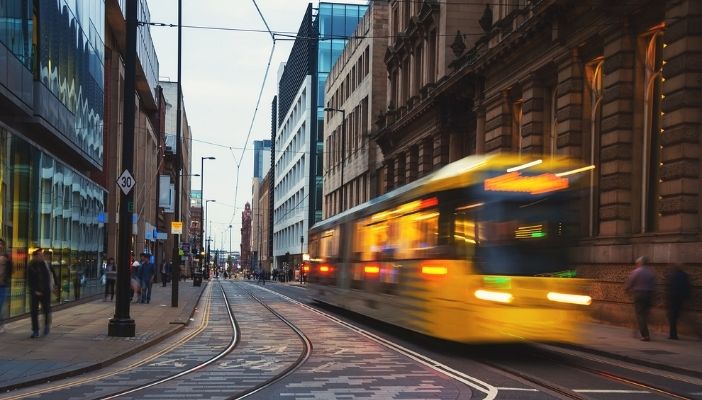 A Metrolink tram travelling through city centre Manchester.