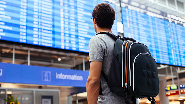 A passenger outside an airport.