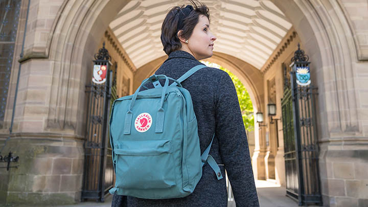 A postgraduate student outside of Whitworth Hall.