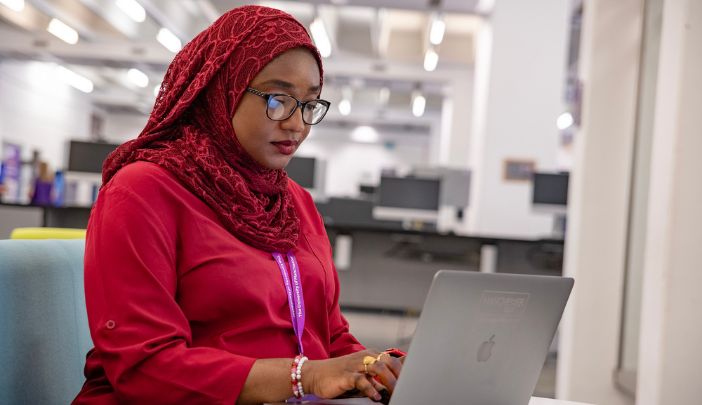 A researcher sat at her laptop typing