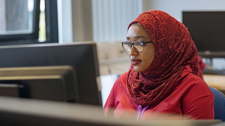 PhD student Suraiya working on a PC.