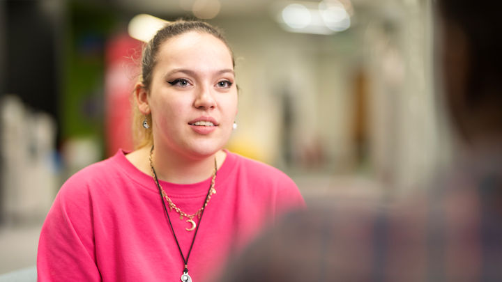 A student talking to someone off-camera.