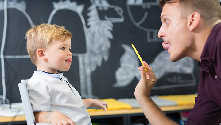 A therapist working on speech with a young patient.