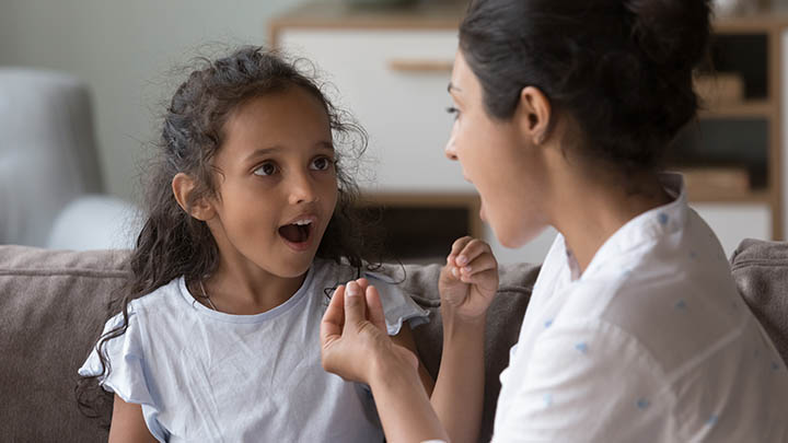 A therapist working on speech with a young patient.