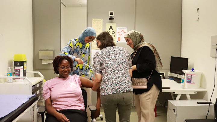 Students practising in a mock medical treatment room.