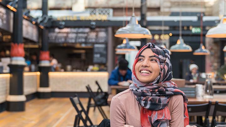 Tasnim, an undergraduate student, eating at a restaurant in Manchester.