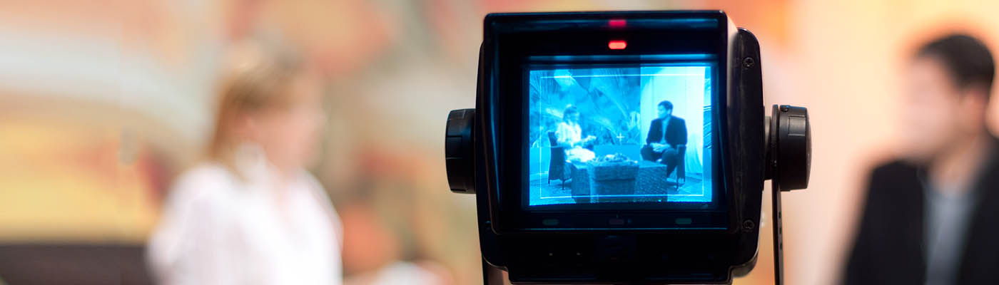 Close-up of video camera recording a lecture.