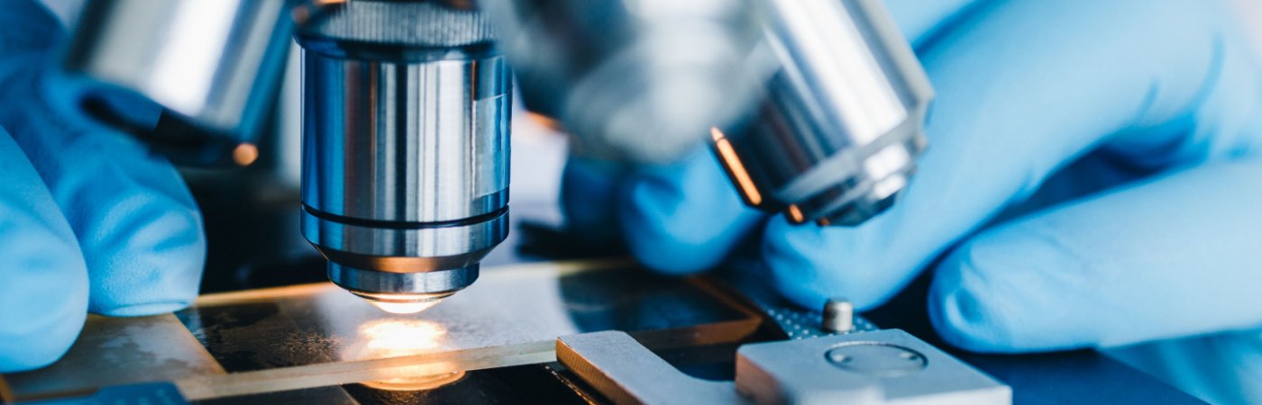 Close-up shot of microscope with metal lens at laboratory.